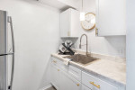 Modern kitchen with stainless steel appliances and marble countertop at Independence Green Apartments