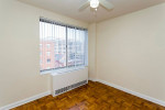 Cozy apartment interior with hardwood floors and large windows in Washington, DC, highlighting urban comfort.