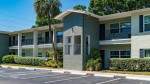 Exterior view of luxury apartments at The Drake, featuring balconies and lush landscaping in St. Petersburg, FL.