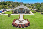Scenic view of The Lodge at Woodlake Apartments community area with landscaped gardens and fire pit.
