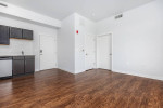 Spacious apartment interior with modern kitchen and large windows at C Street Flats in Laurel, Maryland.