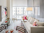 Stylish living room at AVA DoBro apartments in Brooklyn, featuring modern decor and large windows.