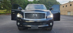 Front view of a 2012 Infiniti QX56, showcasing its clean exterior and open doors.