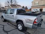 2010 Toyota Tacoma TRD Sport Quad Cab 4x4 in silver, showcasing a clean exterior and pickup truck design.