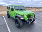 2018 Jeep Wrangler Rubicon 4WD in bright green with off-road accessories parked outdoors