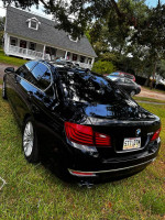2016 BMW 5 Series in perfect condition with new Michelin tires, parked on green grass.