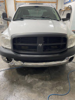 Front view of a 2007 Dodge Ram 2500HD with minor dings, automatic transmission, and new tires.