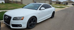 2009 Audi A5 S-Line in white parked on the street, showcasing sleek design and sporty wheels.