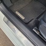 Interior view of a 2017 Volkswagen Passat SEL Premium with Wolfsburg floor mat and PASAT door sill.
