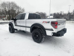 Lifted 2014 Ford F-150 FX4 in snow, showcasing premium features and off-road capability.