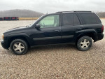 Side view of a 2005 Chevrolet TrailBlazer for sale, showing its black exterior and alloy wheels.