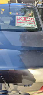 Rear view of a 2010 Ford Fusion for sale, featuring a clean title and various new parts.