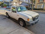 2011 Ford Ranger pickup truck parked on the street, displaying great condition with minimal cosmetic issues.