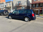 2012 Dodge Grand Caravan parked on the street, featuring Stow n Go seats and low mileage.