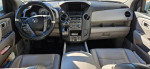 Interior view of a 2013 Honda Pilot Touring showcasing the dashboard and seating area with electronic features.
