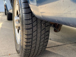 Close-up of new tire on 2004 Chevrolet Astro showing tread and side profile.