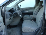 Interior of a Majestic Blue 2008 Nissan Quest minivan, featuring comfortable seating and modern controls.