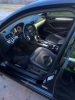 Interior view of a 2013 Volkswagen Passat SE FWD with black leather seats and dashboard, showcasing its clean condition.