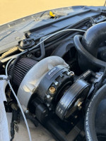 Close-up of ESS supercharger installed on a Ford Mustang GT engine showcasing performance enhancements.