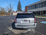 Rear view of a well-maintained 2017 GMC Yukon XL parked, showing its clean Ohio title and good condition.