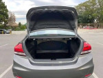 Open trunk of a Honda Civic showing spacious storage area in a parking lot.