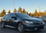 Black Honda Civic with moon roof and backup camera, parked against a scenic backdrop.