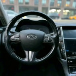 Interior view of an INFINITI Q50 steering wheel and dashboard with premium features.