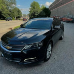Black Chevrolet Impala with clean title, Bluetooth, and Apple Car Play parked on the street.