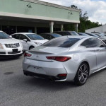 Silver INFINITI Q60 Coupe parked in a lot, showcasing a sleek design and modern styling.