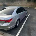 Silver Honda Accord parked, featuring leather seats, Bluetooth, and a clean title.