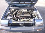 Under the hood of a 1986 Honda Accord EX showing the clean engine and components with low mileage.