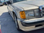 Close-up of a 1987 Mercedes-Benz 190E 2.3-16V Cosworth showing headlights and paint details.