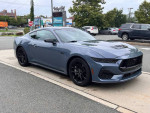 2024 Ford Mustang GT Premium in blue, 3932 miles, parked on the street.