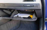Interior view of the glove compartment in a 2008 BMW M3, displaying documents and storage space.