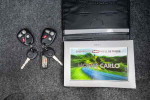 2001 Chevrolet Monte Carlo LS keys and owner's manual on a grey carpet