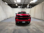 Front view of a red Chevrolet Silverado 1500HD Classic pickup truck in a studio setting