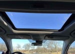 View of the sunroof inside a 2014 Honda Accord EX with a clear blue sky.