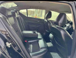 Interior view of a 2018 Toyota Camry XLE with black leather seats, showcasing the back seat area.