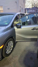 2018 Honda Odyssey LX door open showcasing interior features and spacious seating for 7-8 passengers.