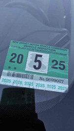 Close-up of a New Jersey vehicle inspection sticker for a 2018 Honda Odyssey LX, valid until May 2025.