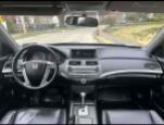 Interior view of a 2012 Honda Accord EX V-6 with clean dashboard and leather seats, showing controls and space.