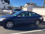 2010 Nissan Altima 2.5 SL sedan parked, showcasing a well-maintained exterior with a blue finish.