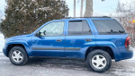 2006 Chevrolet TrailBlazer in blue parked on a snowy street with good tires and clean appearance