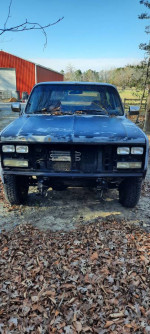 Front view of a 1990 Chevrolet Blazer with new A/C and rebuilt engine, parked in a leaf-strewn area.