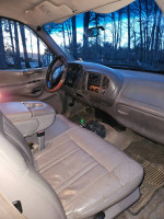 Interior view of a 1997 Ford F-150 Lariat with leather seats and dashboard features.