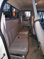 Interior view of the back seat in a 1997 Ford F-150 Lariat 4WD, showcasing grey upholstery.