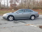 2009 Chevrolet Impala LS in excellent condition, showing side view in a parking area, with clean exterior and new tires.