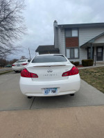 White 2009 Infiniti G37 parked in driveway with great condition exterior and no issues.