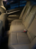 Back seat interior of a 2009 Infiniti G37, showcasing well-maintained leather upholstery.