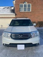 Front view of a 2012 Honda Pilot Touring 4WD, White Diamond Pearl, with up-to-date maintenance and features.